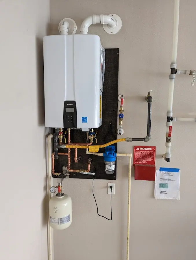 Professional plumber installing copper piping in a Sandersville home